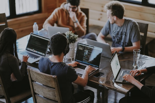 Agency team in a weekly client check-in at a shared workspace
